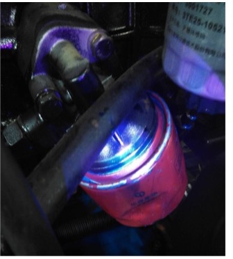 How do a Microscope Fluorescence Adapter and Water Tracing Dye assist in Car Leaks?